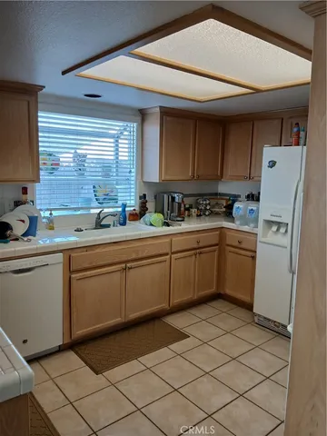 a kitchen with a sink cabinets and window