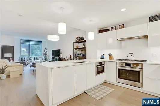a kitchen with white cabinets and appliances