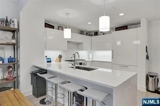 a kitchen with a sink a stove and chairs