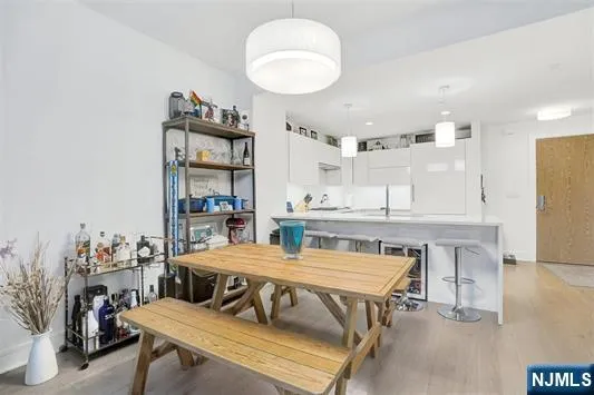 a kitchen with a table chairs and a refrigerator