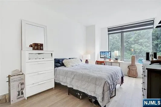 a bedroom with a bed and a large window