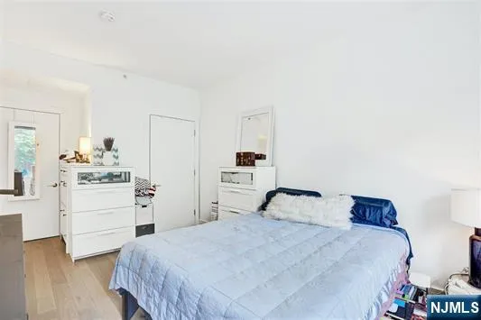 a bedroom with a bed and dresser