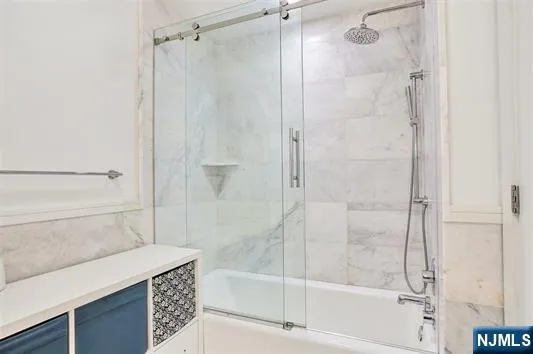 a bathroom with a shower and a bath tub