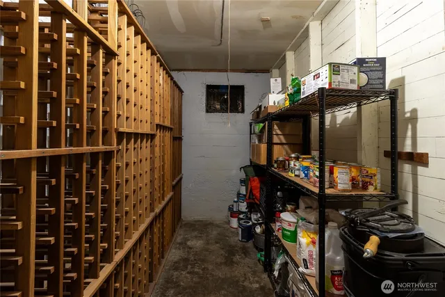 a bedroom with a bed and large windows