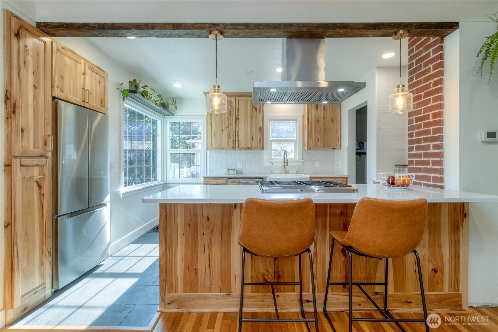 1028 University Street Walla Walla, WA 99362 - Photo 8 of 27 a kitchen with stainless steel appliances granite countertop a table chairs and a refrigerator