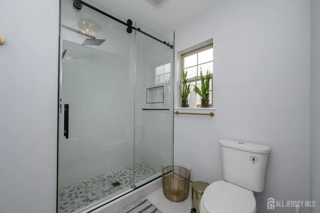 a white toilet sitting next to a bathroom sink
