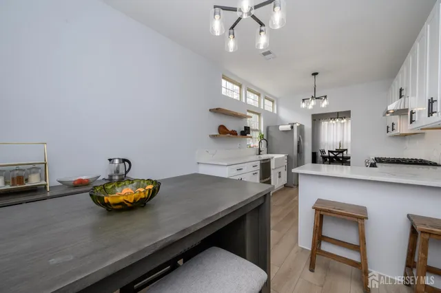 a kitchen with a table and chairs in it