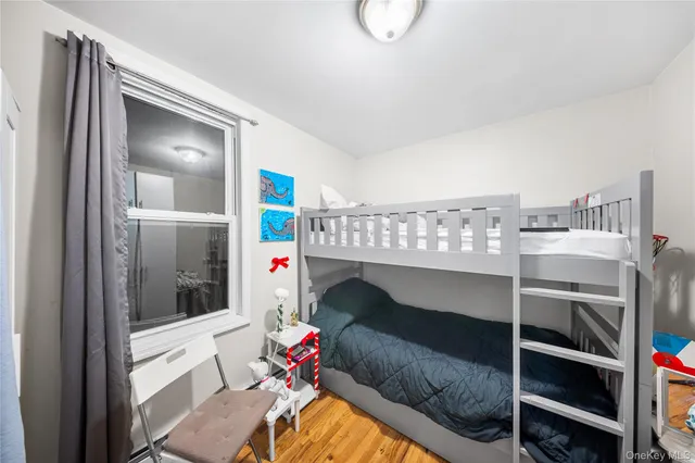 a bedroom with a bunk bed and a window