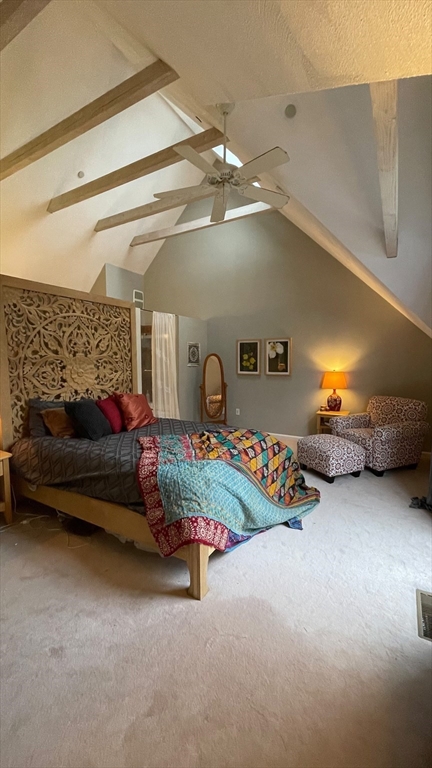 12 Deer Path, Unit 12 Hudson, MA 01749 - Photo 5 of 9 a bedroom with furniture and a chandelier