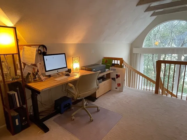 a bedroom with a bed and a desk