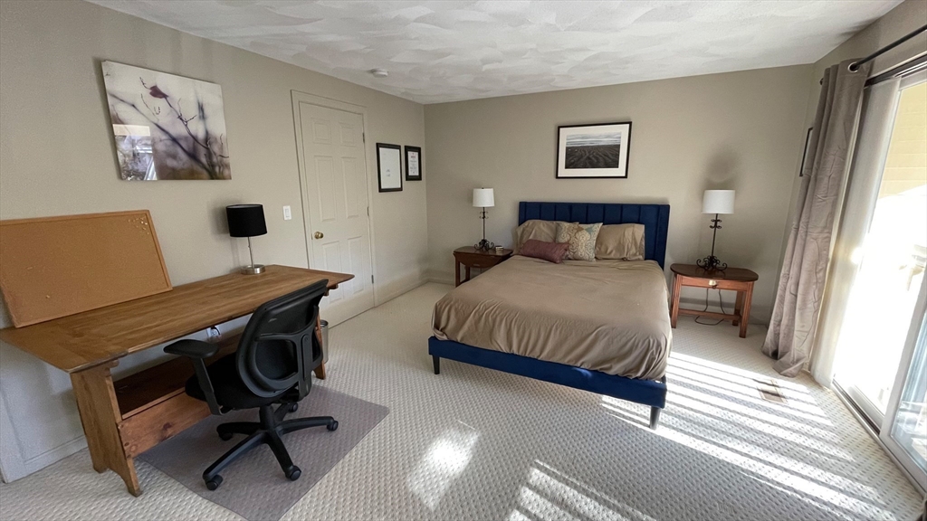 12 Deer Path, Unit 12 Hudson, MA 01749 - Photo 7 of 9 a bedroom with a bed and a desk