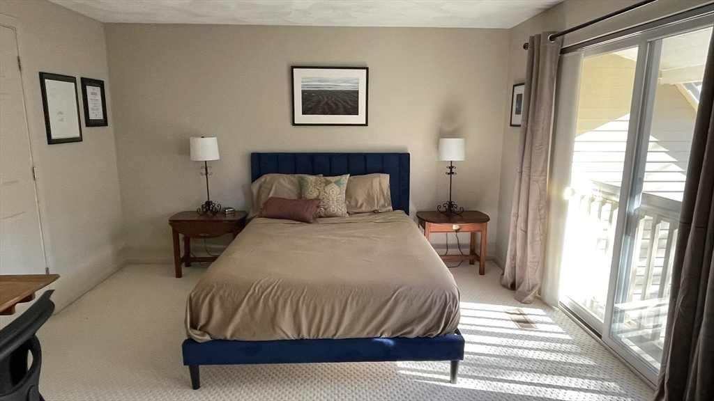 12 Deer Path, Unit 12 Hudson, MA 01749 - Photo 8 of 9 a bedroom with a bed and a window