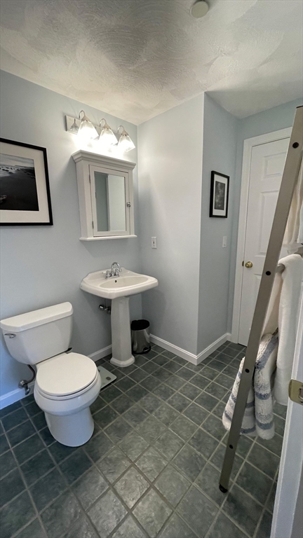 12 Deer Path, Unit 12 Hudson, MA 01749 - Photo 9 of 9 a bathroom with a toilet sink and mirror