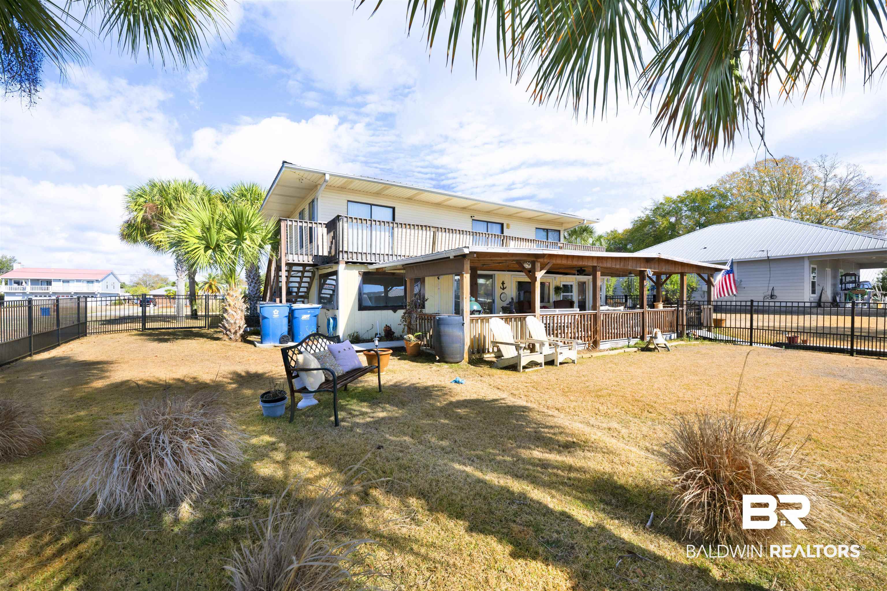 26222 Marina Road Orange Beach, AL 36561 - Photo 36 of 38 Rear view of house with a fenced backyard and a wooden deck