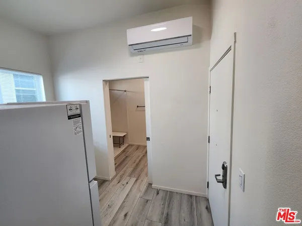 a view of a hallway with wooden floor and entryway