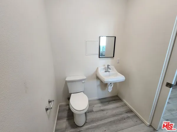a bathroom with a toilet a sink and mirror
