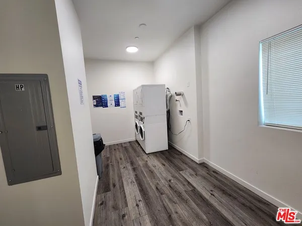 a view of a hallway with wooden floor and closet