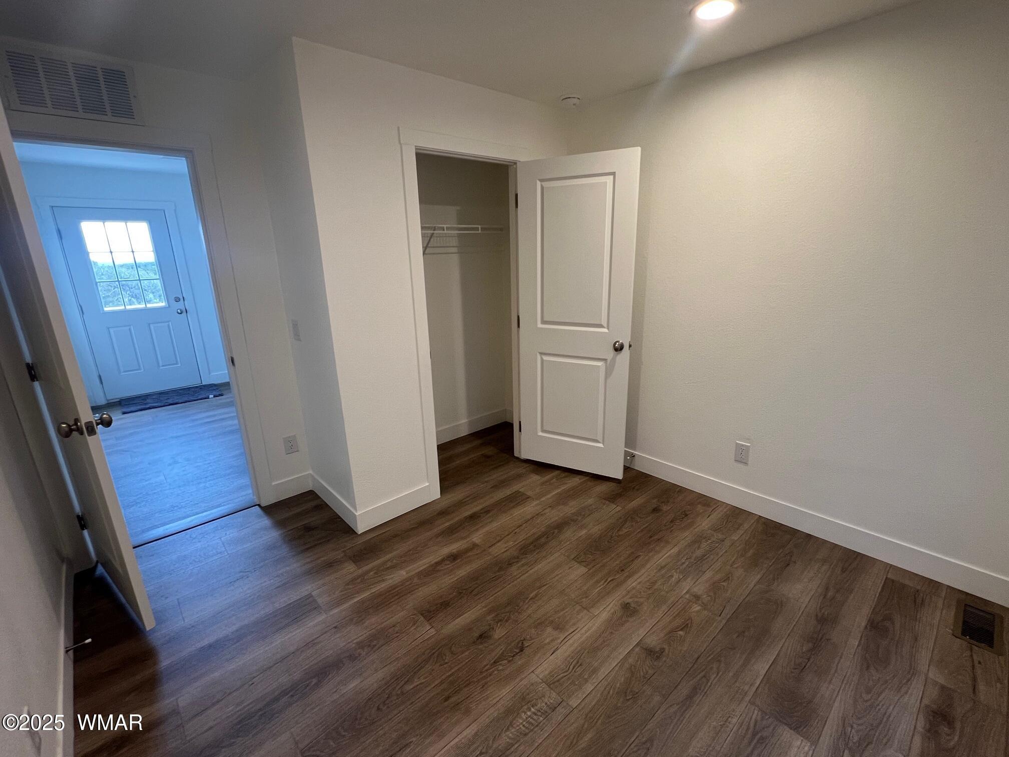 4129 Apache Road Snowflake, AZ 85937 - Photo 17 of 48 a view of an empty room with wooden floor and a window