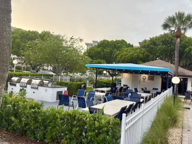 2671 South Course Drive, Unit 108 Pompano Beach, FL 33069 - Photo 24 of 40 a view of an chairs and table in the balcony