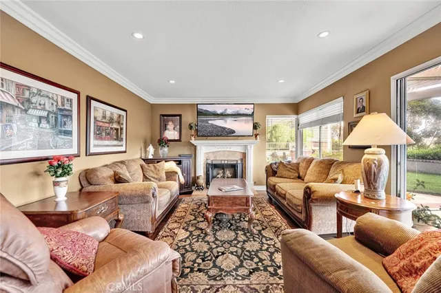 a living room with furniture a large window and a fireplace