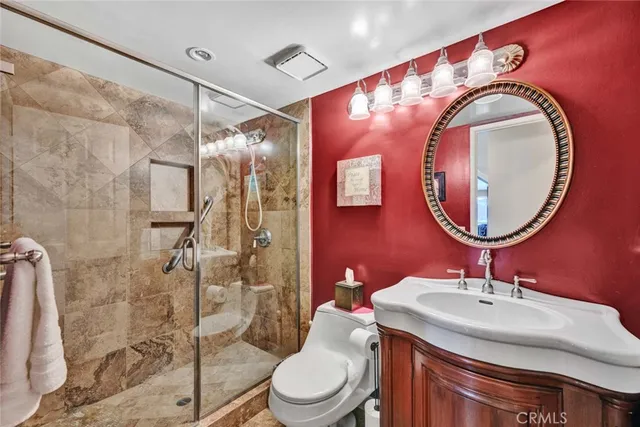 a bathroom with a sink mirror vanity and toilet