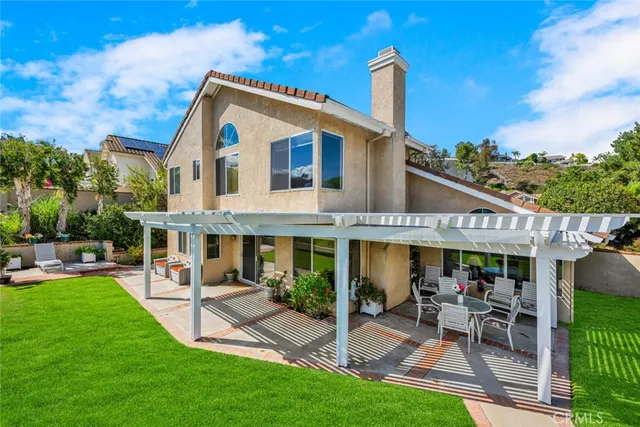 a view of a house with a yard patio and furniture