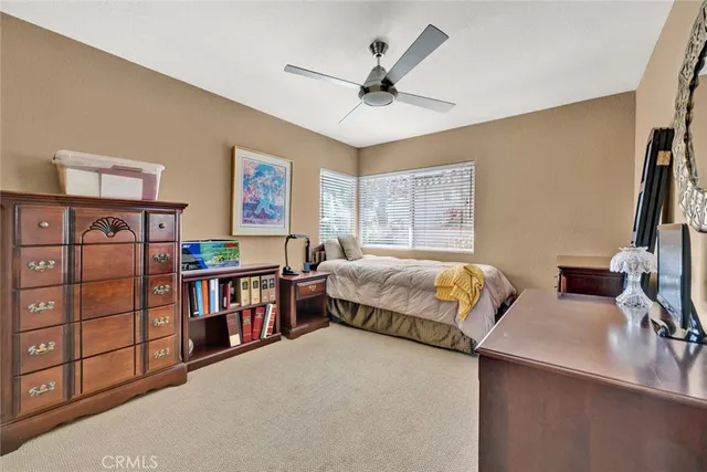 a bedroom with a bed a dresser and book shelf