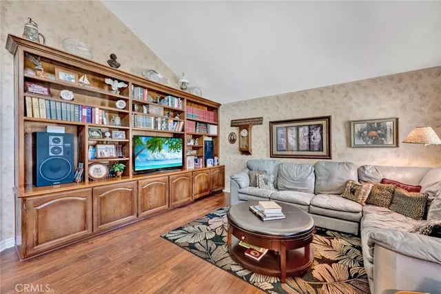 a living room with furniture a rug and a painting