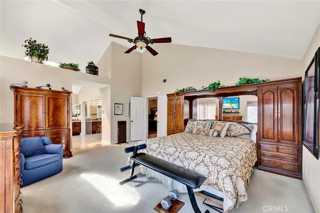 a bedroom with a bed couch and a large window