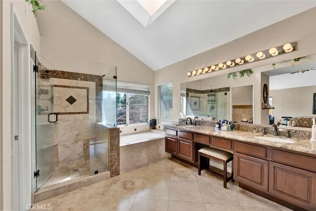a large white bathroom with a large mirror vanity shower and bathtub