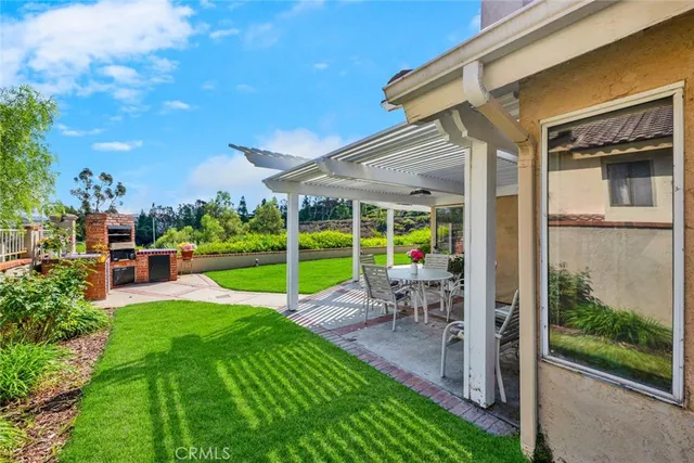 a view of a backyard with sitting area and garden
