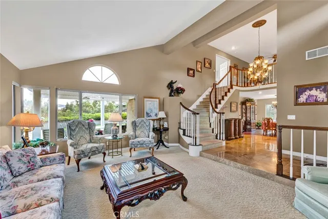 a living room with furniture a table and a large window