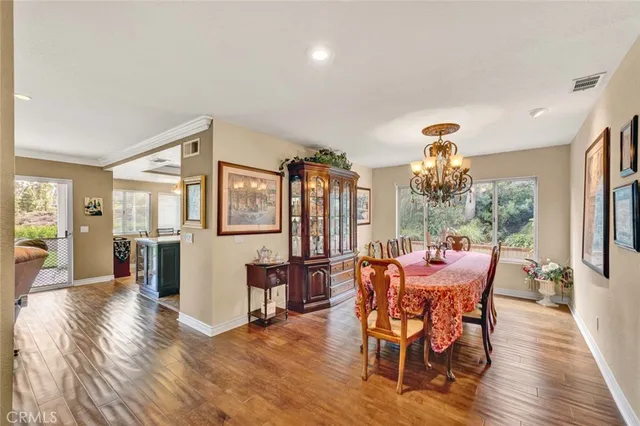 a view of a dining room with furniture large window and wooden floor