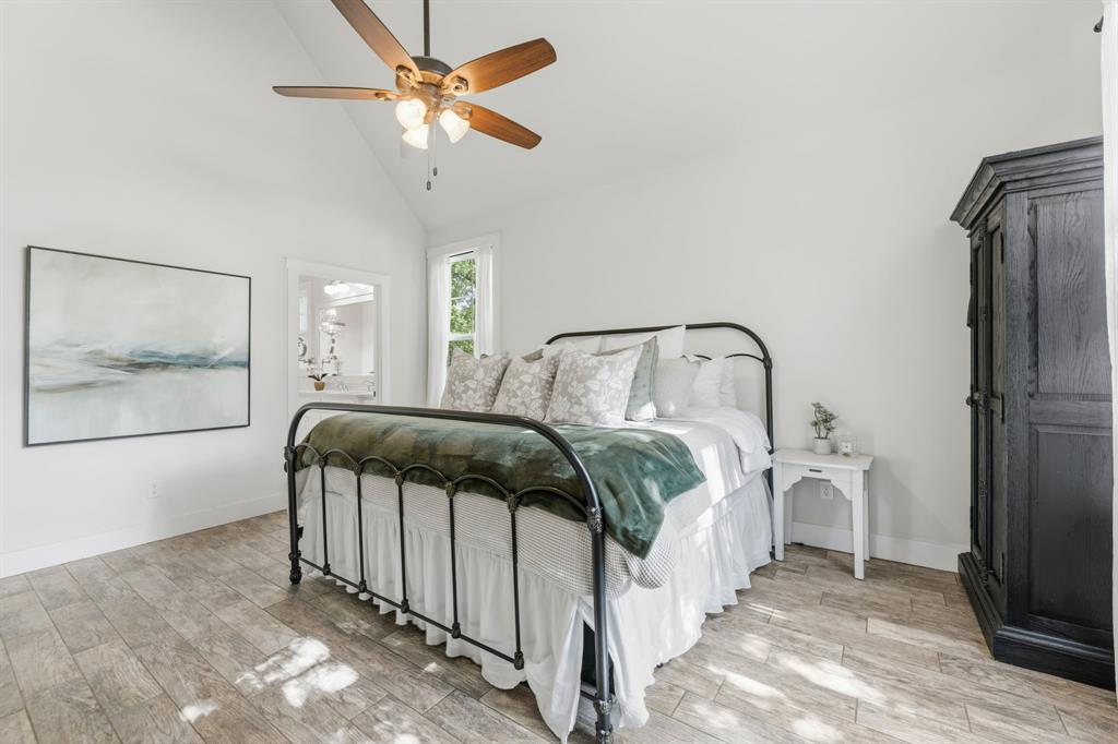 665 Chinn Chapel Road Copper Canyon, TX 75077 - Photo 17 of 26 a bedroom with a bed and a chandelier