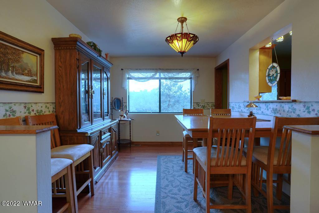 1180 Timberline Drive Eagar, AZ 85925 - Photo 12 of 48 a view of a dining room with furniture and chandelier