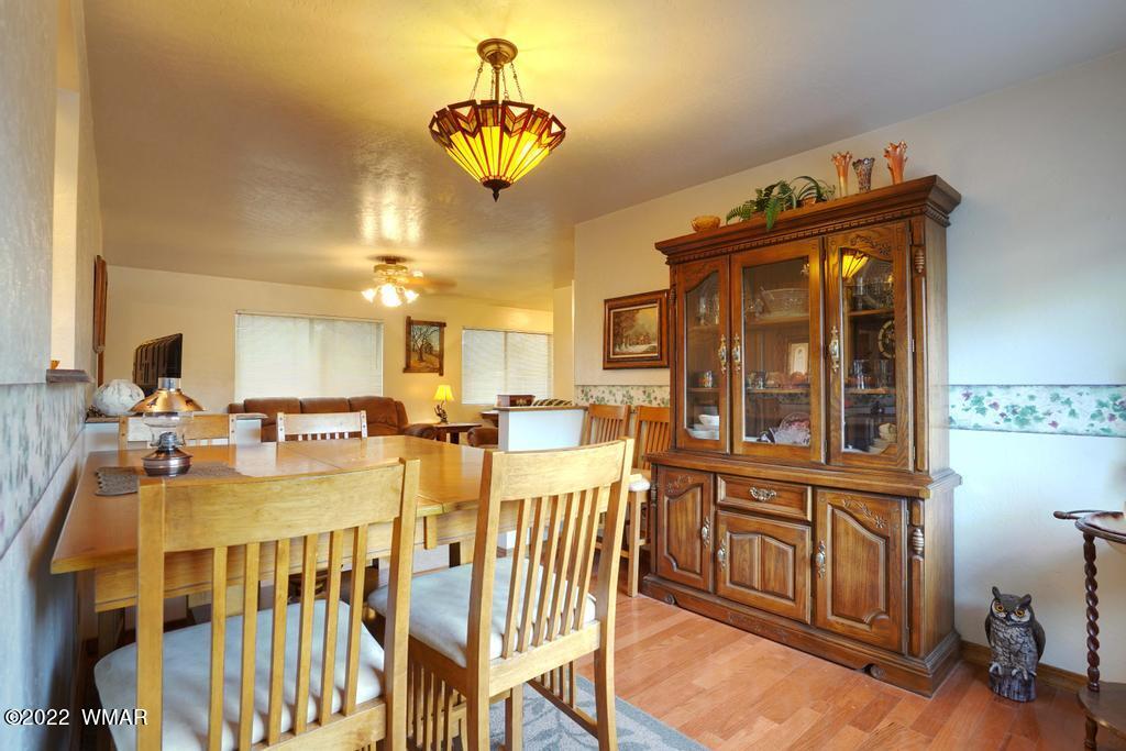 1180 Timberline Drive Eagar, AZ 85925 - Photo 13 of 48 a view of a dining room with furniture and chandelier