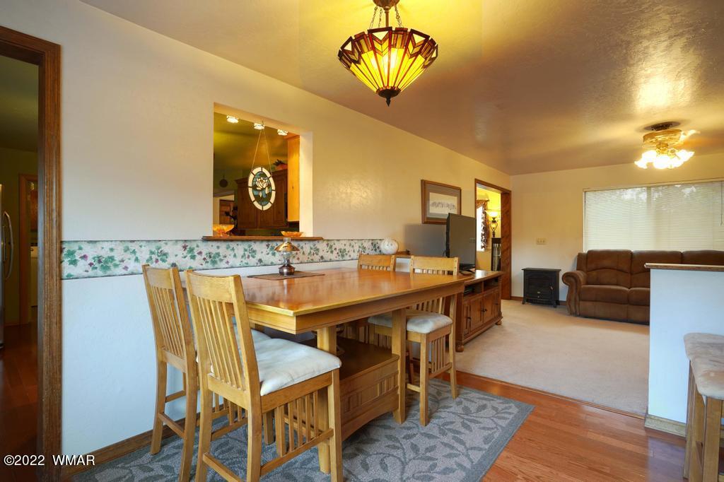 1180 Timberline Drive Eagar, AZ 85925 - Photo 14 of 48 a view of a dining room with furniture and a chandelier