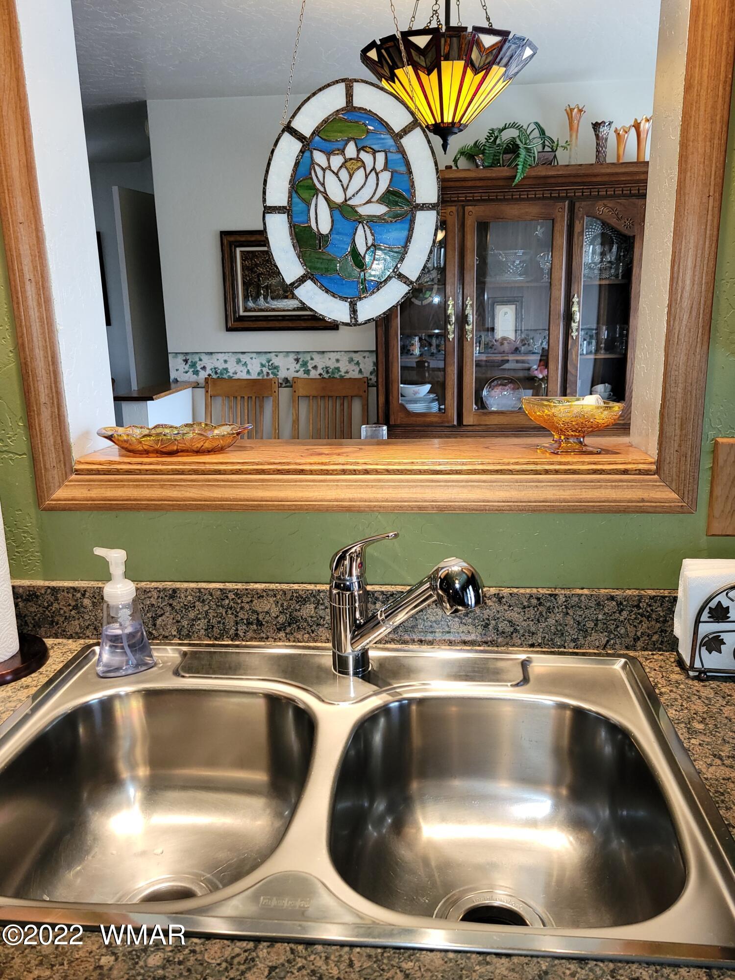 1180 Timberline Drive Eagar, AZ 85925 - Photo 17 of 48 a kitchen sink with a stove a mirror and vanity