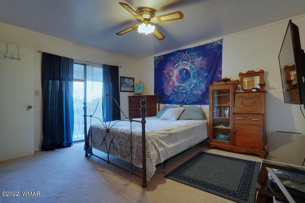 1180 Timberline Drive Eagar, AZ 85925 - Photo 20 of 48 a bed sitting in a spacious bedroom next to a window