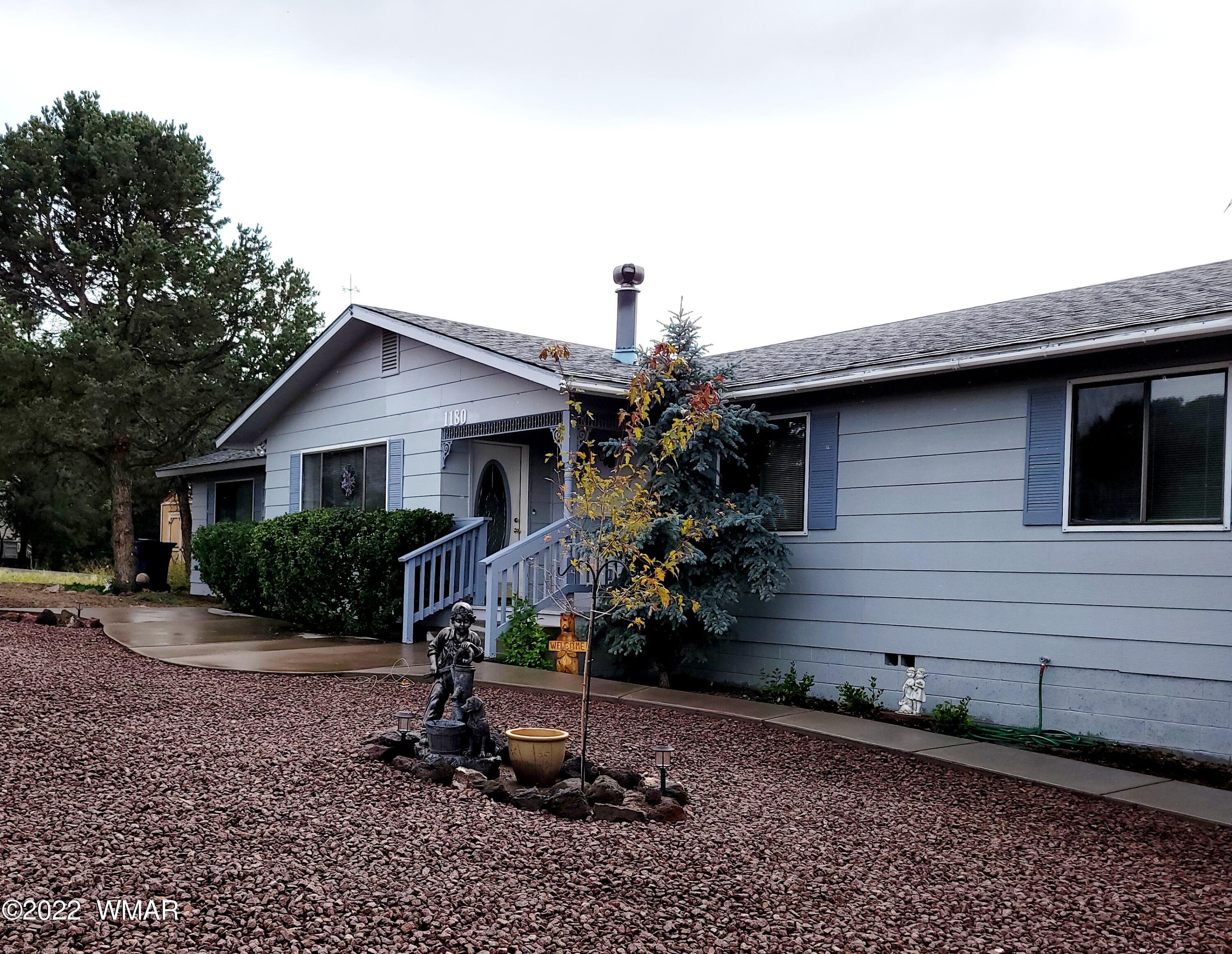 1180 Timberline Drive Eagar, AZ 85925 - Photo 2 of 48 a front view of a house with garden