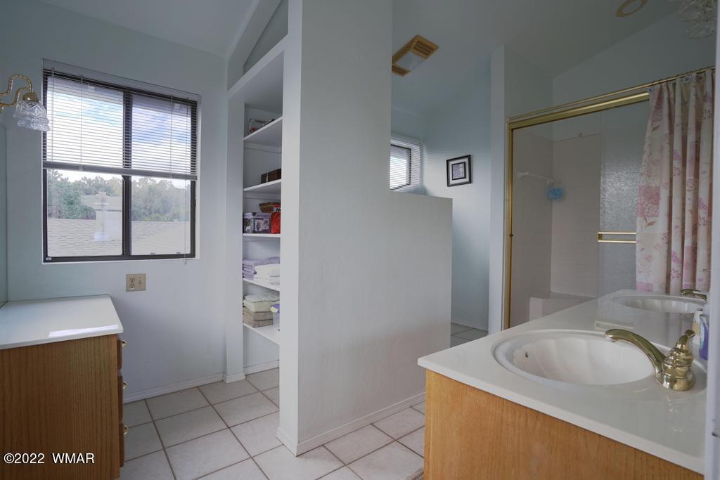 1180 Timberline Drive Eagar, AZ 85925 - Photo 29 of 48 a bathroom with a sink a vanity and a mirror