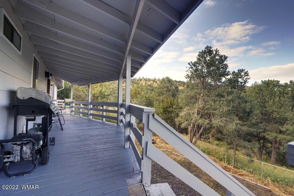 1180 Timberline Drive Eagar, AZ 85925 - Photo 34 of 48 a balcony with wooden floor and outdoor seating