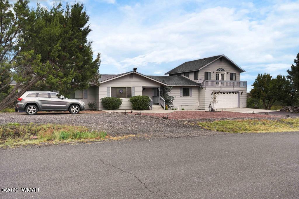 1180 Timberline Drive Eagar, AZ 85925 - Photo 47 of 48 a house with a large window and large trees