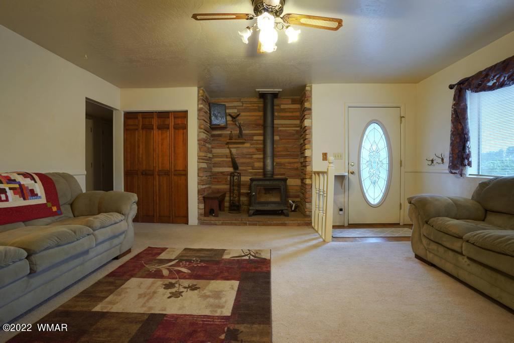 1180 Timberline Drive Eagar, AZ 85925 - Photo 5 of 48 a living room with furniture a air conditioner vent and a window