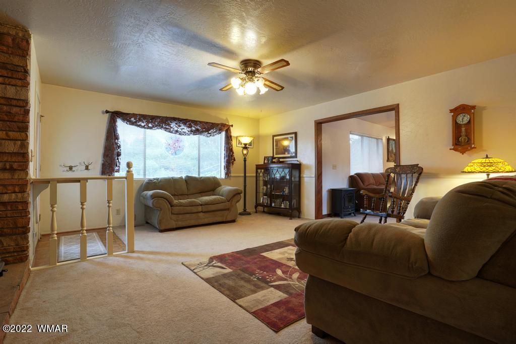 1180 Timberline Drive Eagar, AZ 85925 - Photo 6 of 48 a living room with furniture and a large window