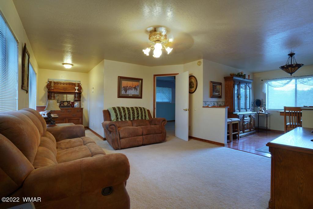 1180 Timberline Drive Eagar, AZ 85925 - Photo 7 of 48 a living room with furniture and a chandelier