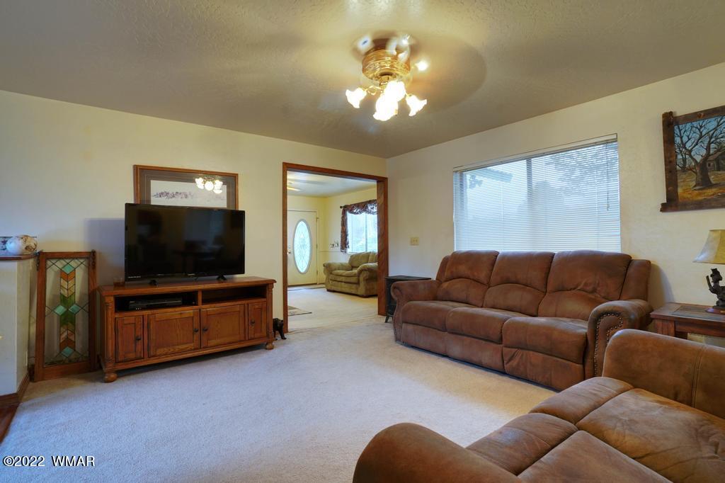 1180 Timberline Drive Eagar, AZ 85925 - Photo 8 of 48 a living room with furniture and a flat screen tv