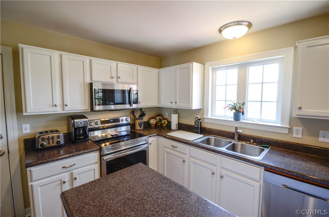 4400 Spring Rock Road Gum Spring, VA 23065 - Photo 13 of 35 a kitchen with sink a microwave and cabinets