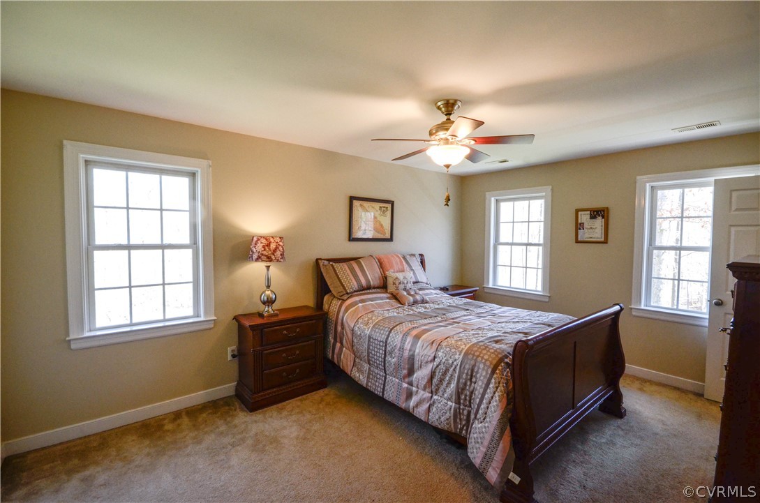 4400 Spring Rock Road Gum Spring, VA 23065 - Photo 20 of 35 a bedroom with a bed next to a window and a chandelier