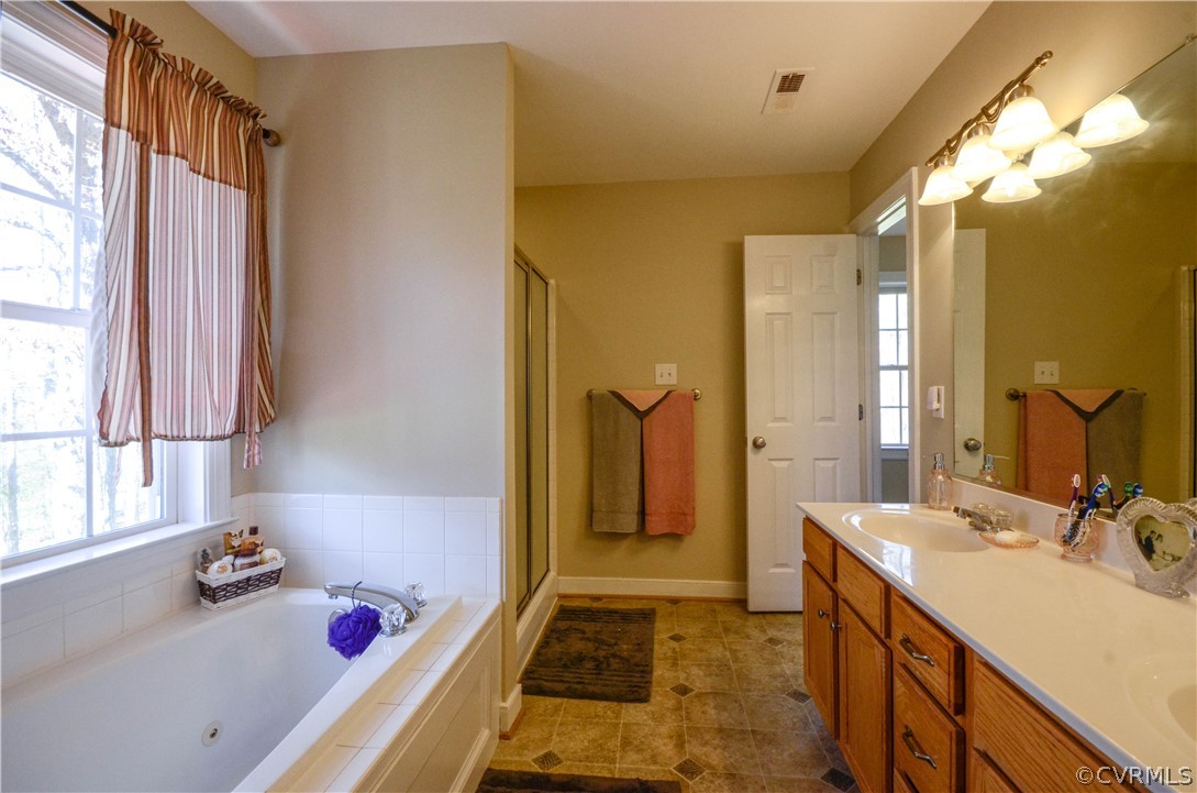 4400 Spring Rock Road Gum Spring, VA 23065 - Photo 23 of 35 a bathroom with a tub sink and a mirror
